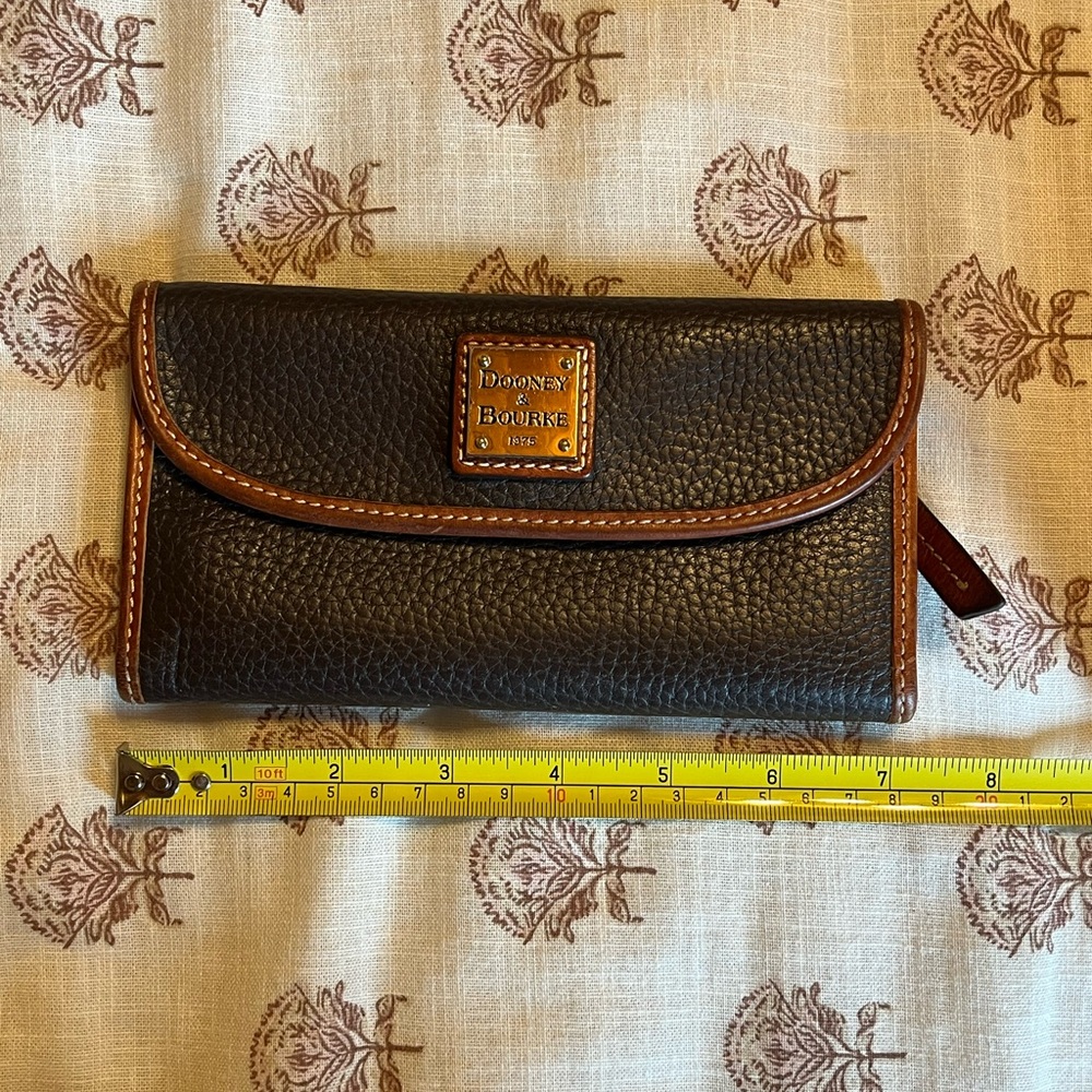 Dooney & Bourke Black Pebbled Leather Wallet with Brown Trim and Logo Plaque